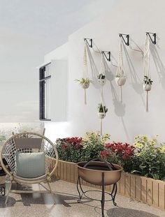 an outdoor patio with potted plants and hanging planters on the wall next to it