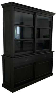 a black cabinet with glass doors and drawers