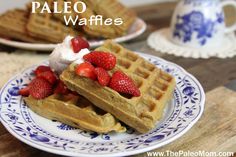 two plates with waffles and strawberries on them