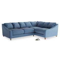 a blue sectional sofa with pillows on the bottom and one arm folded open to show it's back end