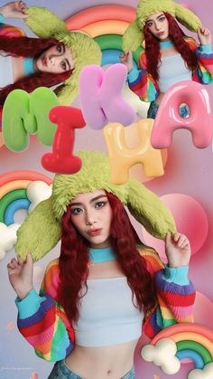 a woman with long red hair wearing a green hat in front of a rainbow background