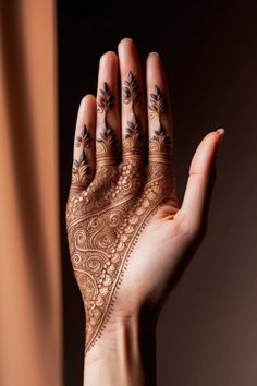 a woman's hand with henna on it