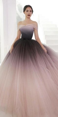 a woman in a pink and black ball gown