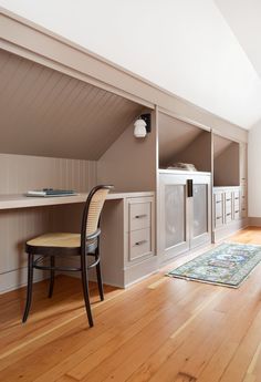 a chair and desk in an attic room