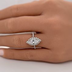 a woman's hand with a diamond ring on it