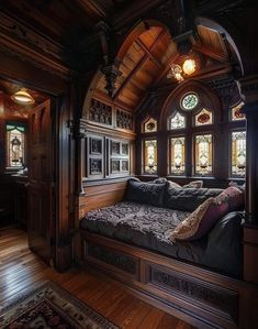 a couch sitting in the middle of a room with stained glass windows on each side