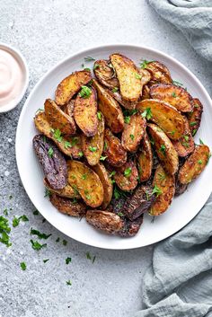 roasted fingerling potatoes on a white plate with parsley in the middle and title