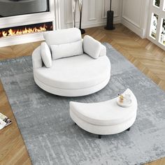 a living room with white furniture and a fireplace