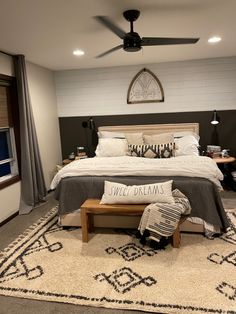 a bedroom with a bed, rugs and ceiling fan in it's center