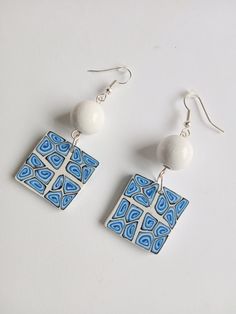 Bead earrings with handmade polymer clay white & blue fantasy design beads. Colors are mixed by hand. Each square bead is a cool colour combination and is truly unique. White wooden bead size is 1.2 cm Square polymer clay bead size is 2.5cmx2.5cm Earring drop length is 5.0 cm. All earrings metal parts are nickel-free and silver plated. They are lightweight and easy to wear. Modern and cute earrings for casual and stylish everyday wear. The color may be slightly different due to personal monitor settings. Please, pay attention to FAQs and if you have any question, don't hesitate to ask.  Thank you for visiting my shop! Hand Painted White Earrings As A Gift, Hand Painted White Earrings For Gift, Unique White Earrings With Ear Wire, White Hand Painted Earrings For Gift, Unique White Earrings For Gift, Abstract Design Drop Earrings As Gift, White Hypoallergenic Beaded Earrings As Gift, Unique White Hypoallergenic Earrings, Hypoallergenic White Beaded Earrings For Gifts