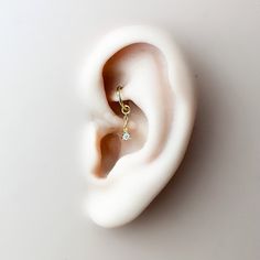 an ear with a single diamond in it