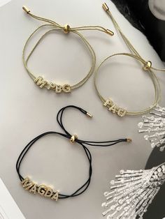 This Custom Cord Bracelet offers you a unique and stylish way to express your individuality. Crafted with beautiful zirconia gold plated letters and adjustable cords in both black and gold, it's the perfect accessory to make an unforgettable statement. Carrie Necklace, Heart Hoop Earrings, Clover Necklace, Cord Bracelet, Black Necklace, Cord Bracelets, Letter Necklace, Dream Jewelry, Heart Bracelet