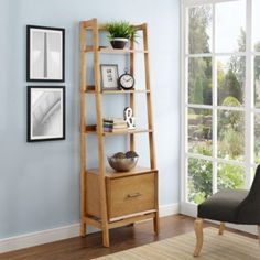 a wooden shelf sitting next to a chair in a living room