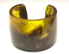 A stunning vintage bangle made from carved resin, which has a translucent quality . Mottled shades of yellow  and brown make up this chunky heavy weight bangle /cuff . The band Measures 6 cm wide and inside across at widest point is 6.5 cm wide. A lovely classy, elegant, statement bangle which will complement  most outfits . Gift wrapped and ready to wear. Braids Maid Dresses, Marble Resin, Bangles Making, The Bangles, Vintage Bangles, Cuff Bangle Bracelet, Funky Jewelry, Shades Of Yellow, Cuff Bangles