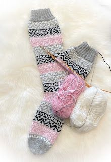 a pair of socks with yarn and knitting needles