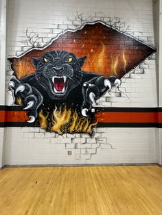 a wall painted with an image of a black cat on it's face and flames coming out of its mouth