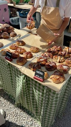 a table topped with lots of pastries on top of a green and white checkered table cloth