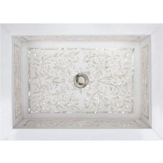 a white square ceiling fixture with an intricate design on the top and bottom panel,