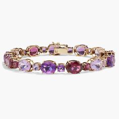 Infuse your style with sparkle as you wear this bracelet featuring gorgeous cushion- and oval-cut amethyst and rhodolite stones. The timeless gleam of the 14k yellow gold design completes the luxurious effect. Elegant Amethyst Bracelets With Gemstone Accents, Elegant Purple Multi-stone Gemstones, Luxury Purple Jubilee Bracelet, Elegant Purple Gemstone Bracelets, Luxury Yellow Gold Amethyst Bracelets, Elegant Amethyst Jubilee Bracelet, Elegant Jubilee Amethyst Bracelets, Luxury Amethyst Jubilee Bracelet, Elegant Amethyst Gemstone Bracelets