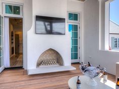 a living room filled with furniture and a flat screen tv mounted to the side of a wall