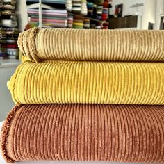 three different colored towels stacked on top of each other