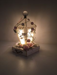 a light that is sitting on top of a box with flowers in the bottom and sides