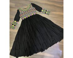 Exclusive Black Anarkali Gown Full Flair gown 15 mtr Flair Navratri Gown 5 frill Gown Partywear gown Readymade Black Gown Gamthi Garba Gown  NAVRATRI COLLECTIONS-2024  Gown :-   Fabrics & Work :- Faux Blooming  Fabric with Kutchi Gamthi Work  Size :- L Size (40 Inch Stitched) {User can adjust From 38" to 44" for your body comfort)}  Stitching :-  5 Layers Gathering Stitching   Length :- 55 Inch  Flair :- 15 Meter  Sleeves :- Full Sleeves  Neck :- Fancy Front and back neck   Lining(Inner) :- Cott Paithani Gown, Navratri Gown, Frill Gown, Flair Gown, Gamthi Work, Black Anarkali, Anarkali Gown, Black Gown, Full Sleeves