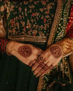 a close up of a woman's hands with hennap and jewelry on