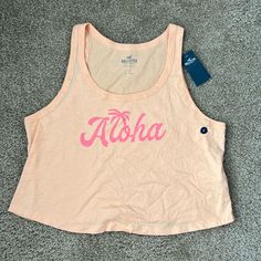 Cropped Tank Top With Aloha Written On The Front Size: L Nwt - Never Worn! Smoke Free And Pet Free Home Pink Cotton Tank Top For Vacation, Pink Beachy Tops For Spring, Pink Tank Top For Beach Vacation, Pink Cotton Tops For Vacation, Pink Summer Top For Vacation, Pink Summer Tops For Vacation, Pink Summer Vacation Top, Pink Summer Vacation Tops, Pink Sleeveless Beachy Top