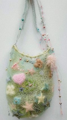 a purse hanging on the wall with beads