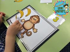 a young boy is working on his monkey themed activity