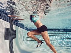 a woman in a swim suit is swimming under water