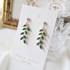 Dainty Emerald green leaf earrings. ♥ Material - Gold or Rhodium (White gold) plated over brass and Glass stone ♥ Earring total length - 38 mm (app. 1.5 inches) ♥ Stone Measurement - H. 30mm x W. 10mm  ♥ All the jewelry comes with gift wrap ♥ Please check the shop policy before you buy the products. Green Stone Earrings, Emerald Earrings Drop, Earrings Bridesmaid, Bridesmaid Necklace, Emerald Earrings, Silver Drop Earrings, Green Leaf, Bridesmaid Earrings, Earrings Sterling Silver