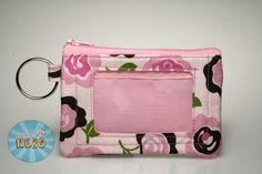 "This ID/coin purse features a pink floral pattern. It is lined with light pink cotton and has a vinyl ID window for a license or school ID. It would be perfect for any fan of pink! This mini wallet would be great to carry your money and cards without having to lug around a purse or giant wallet!  It's perfect to hold your school or work ID with a little bit of extra cash for that run to the vending machine halfway through the day. You'll always have what you need close by with this ID wallet. T Pink Pouch Wallets For Personal Use, Pink Coin Purse With Cell Phone Pocket For Gift, Pink Coin Purse With Card Slots For Personal Use, Compact Pink Coin Purse With Removable Pouch, Pink Rectangular Coin Purse With Card Slots, Pink Wallets With Interior Card Slots For Personal Use, Pink Wallets With Interior Card Slots, Rectangular Pink Coin Purse For Personal Use, School Id