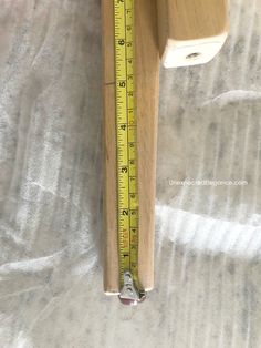 a wooden object with a measuring tape on it