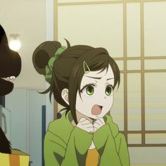 an anime character with her tongue out and another person in the background looking at her