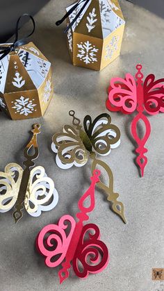 some paper cut outs sitting on top of a table next to scissors and other items