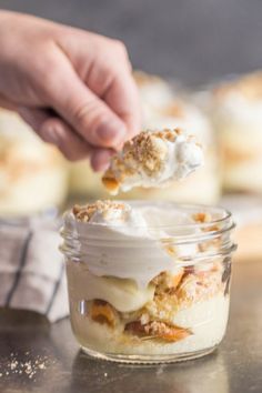 a person is dipping some food into a jar