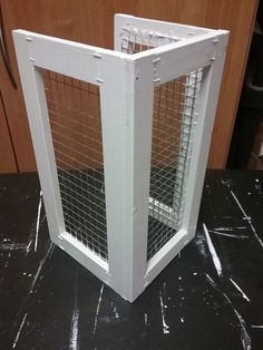 a close up of a metal cage on a table