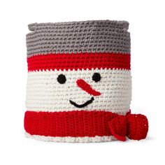 a crocheted snowman basket with a red hat and scarf around it's neck