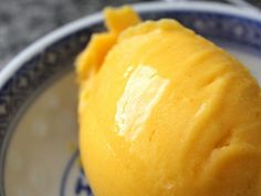 a close up of an orange on a plate