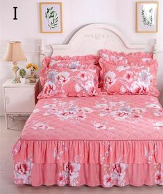 a bed with pink bedspread and flowers on it