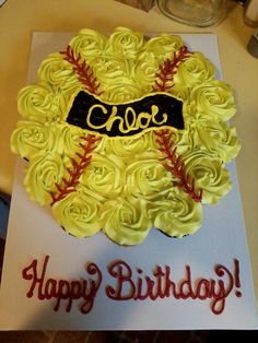 a baseball themed birthday cake with roses in the shape of a wreath