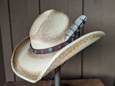 The Cassidy starts with a soft palm hat body that has been flame distressed so it looks like it has already been broken in. The brim is approximately 4" and the crown is 5". There is a wire in the brim so you can shape it however you want. The leather hatband is new rein leather and has lots of Southwestern Conchos. The back of the band has a deer antler bead for accent. Stampede strings are attached to hat which will make it a great hat for riding or on those windy days. Finished with an Owl fe Antler Beads, Owl Feather, Hat Holder, Cloth Tape, Turkey Feathers, A Deer, Deer Antler, Deer Antlers, Felt Hat