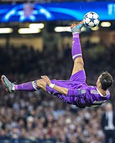 a soccer player is in mid air after kicking the ball