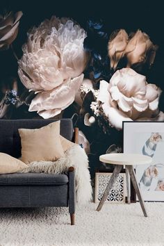 a living room scene with focus on the couch and wallpaper that has large flowers