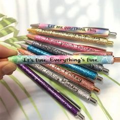 there are five pens with writing on them in the shape of letters that say, let me overthik this it's fine everything's fine