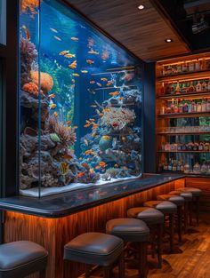 a fish tank in the middle of a bar with stools