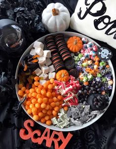 a bowl filled with candy and halloween treats