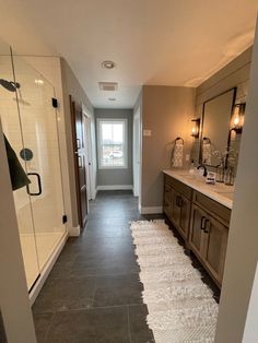 a large bathroom with tile flooring and wooden cabinetry, along with a walk in shower